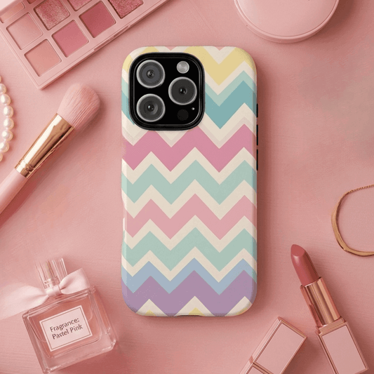 iPhone 16 Pro tough phone case with pastel chevron zigzag pattern on a pink surface with makeup items