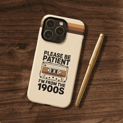 Tough phone case with a vintage cassette tape design on a wooden surface 