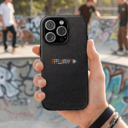 Hand holding a black vintage Press Play tough phone case at a skate park