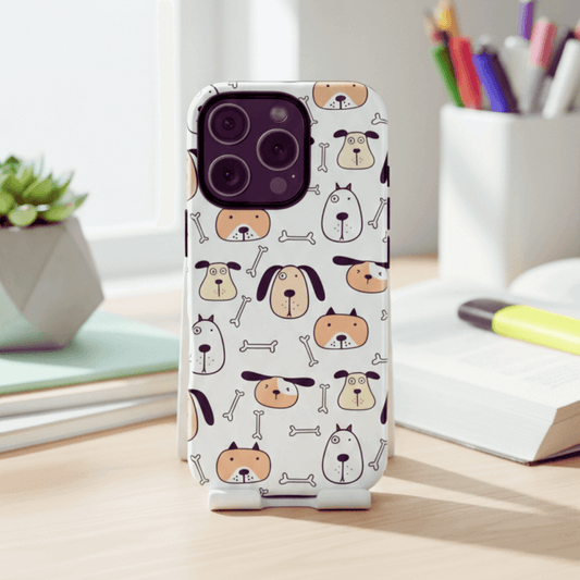 iPhone 16 Pro tough phone case with dog and bones pattern on a desk with stationery items