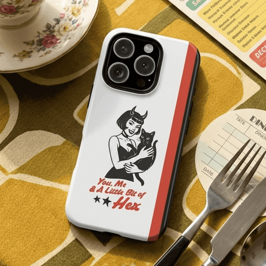 Tough phone case with a design of a woman holding a cat in black on a dining table