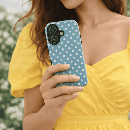 A girl holding a Dusty Blue Polka iPhone 17 tough case