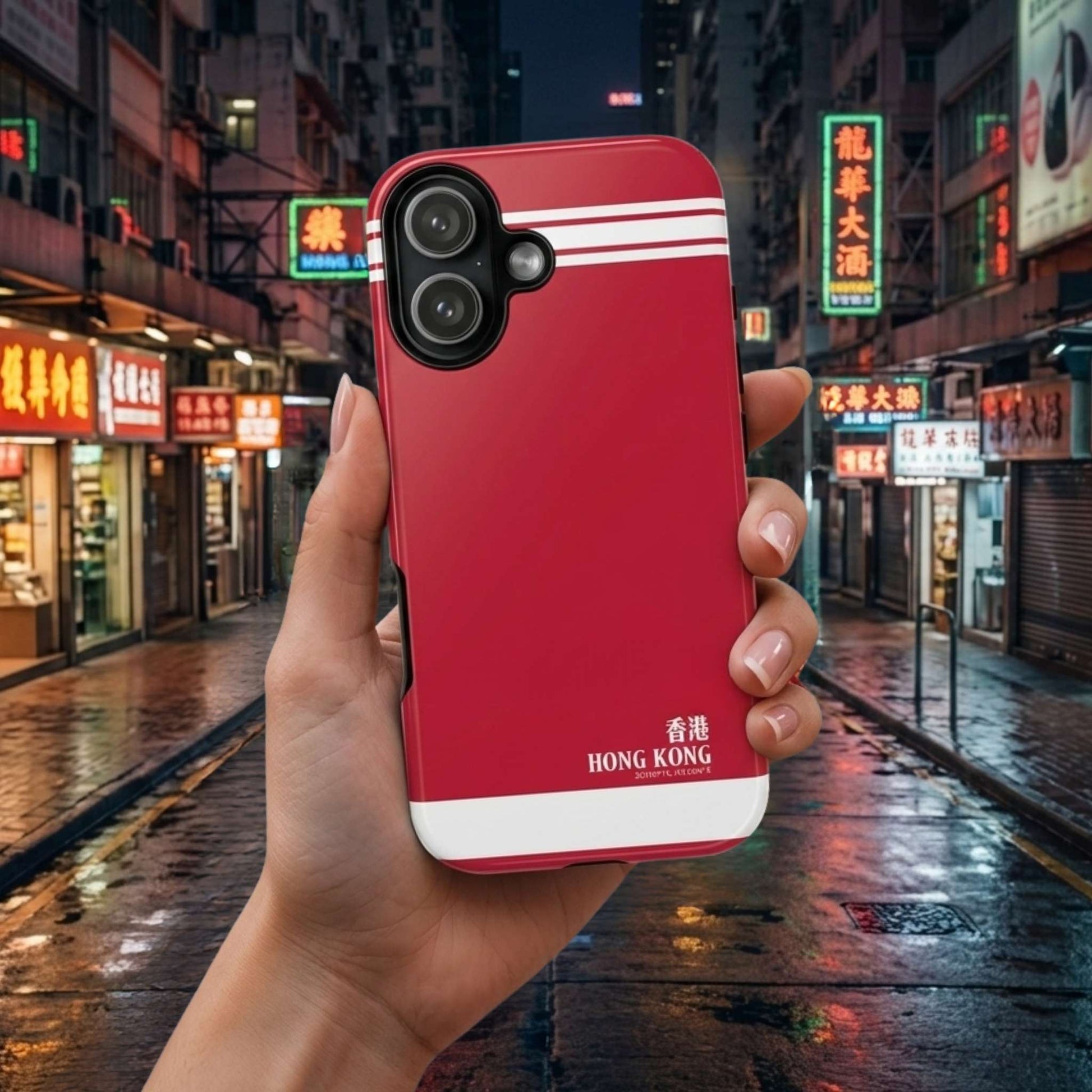 iPhone 17 red phone case with Hong Kong text held in front of a city street at night
