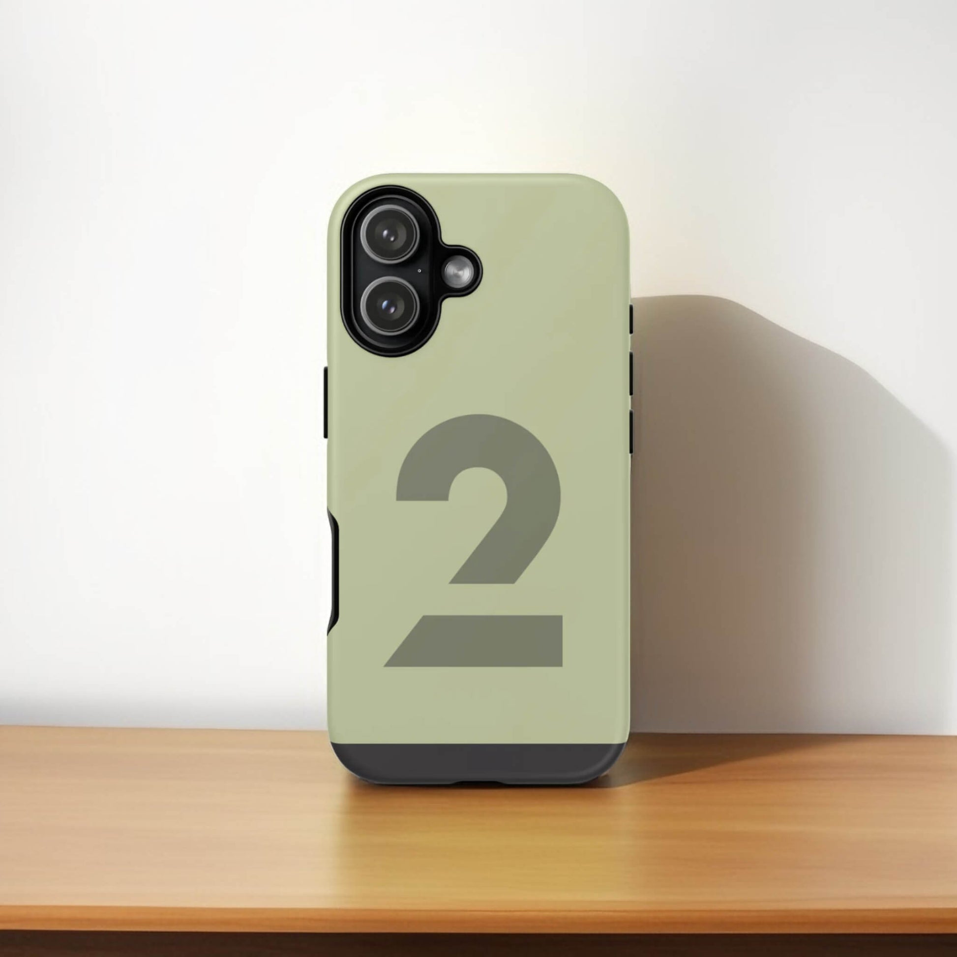 iPhone 17 tough phone case with number '2' on a wooden surface