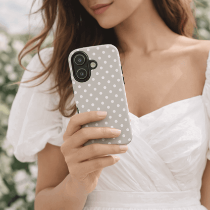 Woman holding a iPhone 17 tough case with a slate polka dot